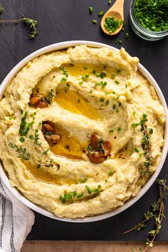 a bowl filled with mashed potatoes and garnished with parsley