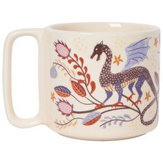 a ceramic mug with a horse and flowers painted on the side, sitting on a branch