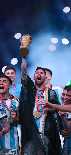 a group of men standing next to each other holding up trophies