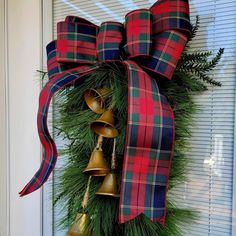 a christmas wreath with bells hanging from it