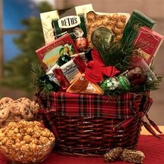 a basket filled with cookies and snacks sitting on top of a red cloth covered table