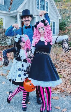 two people dressed up in halloween costumes posing for a photo with a child and an adult