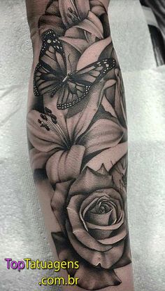 a black and white rose with butterflies on it's arm, done by tattoo artist person