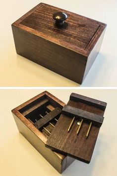 an open wooden box with some pens in it