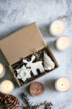 an open box filled with candles and decorations