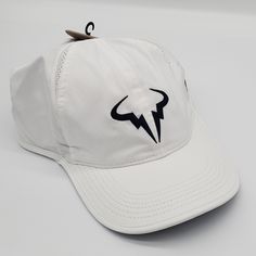 Brand: Nike Model: Dri-Fit Rafa Nadal Logo Strapback Size: Men's L/Xl Condition: New Color: White Features: Dri-Fit Technology To Keep You Dry And Comfortable, Design With The Rafa Nadal Logo, Adjustable Strap For A Perfect Fit. :Shipping: Shipping That Same Day Or The Next Day On Business Days After Purchase White Sporty Dad Hat With Flat Bill, Nike White Visor Hat, White Adjustable Dad Hat, White Nike Sports Hats, White Nike Hat With Curved Visor, White Sporty Dad Hat For Sports, White Baseball Cap For Sports, One Size, White Curved Bill Dad Hat For Sports, Adjustable White Dad Hat For Sports