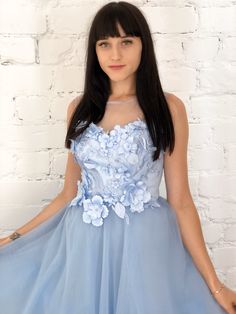 a woman in a blue dress posing for the camera