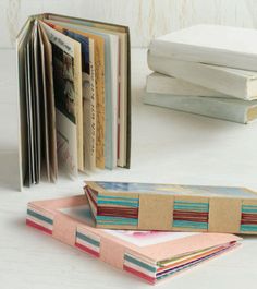 there are several books on the table and one is folded in different colors, shapes and sizes