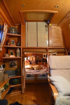 there is a bunk bed in the corner of this room with built - in bookshelves