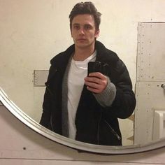 a man taking a selfie in front of a mirror