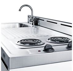 a stove top with two burners and a faucet mounted on the side