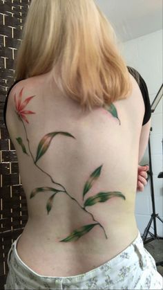 the back of a woman's body with flowers painted on it