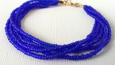 "Stunning royal blue bracelet constructed with 5 strands of high quality of seed beads. Available in several sizes and you can choose from silver or gold clasp. Find a fabulous matching necklaces here: https://www.etsy.com/shop/StephanieMartinCo/search?search_query=sapphire+blue+necklaceℴ=date_desc&view_type=gallery&ref=shop_search ❤ SIZES This item comes in several sizes, kindly choose at checkout. The standard size for an average woman is 7\". For a child, perhaps a 6\" would be approp Royal Blue Bracelet, Teal Bracelet, Beautiful Anklet, Blue Beaded Bracelets, Seed Bead Bracelet, Etsy Bridesmaid Gifts, Jewelry Essentials, Bridesmaid Bracelet, Stretchy Bracelets