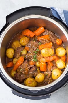 a pot full of stew with carrots and potatoes