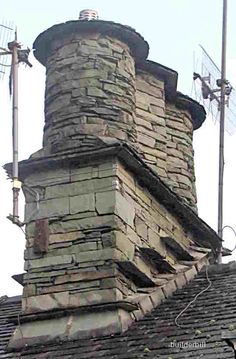 an old brick chimney on top of a roof