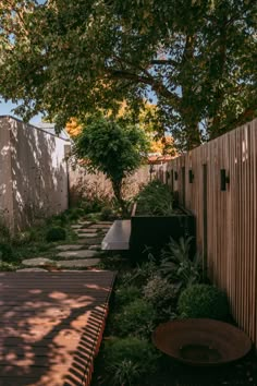 an outdoor garden with wooden fence and trees