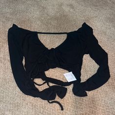 Never Worn, Tags On It Black Long Sleeve Top Cropped Black String Back V Neck Tie Front Black Long Sleeve Tops With Cutout, Long Sleeve Cutout Top For Summer, Black Long Sleeve Cutout Top, Summer Long Sleeve Cutout Tops, Black Long Sleeve Crop Top For The Beach, Black Long Sleeve Top With Cutout, Black Cutout Crop Top For Party, Black Cutout Tops For Night Out, Chic Black Crop Top With Cutout