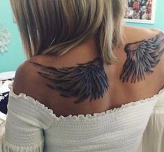 the back of a woman's shoulder with wings on it