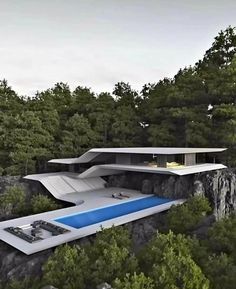 a futuristic house on top of a cliff with a pool in the foreground and trees surrounding it