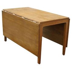 a wooden desk with one drawer open on the top and two drawers closed at the bottom