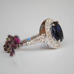 "A ring style of the royalties, this design flaunts an oval synthetic blue stone, surrounded by 0.66cts of double natural diamond halo. Crafted in solid 14k gold, the shank tapers and has diamonds enhancing the overall look. * Center Stone : Blue Sapphire Imitation (for natural, please message) * Shape : Oval (10x8 mm) * Halo Gemstones : Natural Genuine Diamonds * Diamond Wt. : 0.66 Cts * Color/Clarity : H-I, Vs-Si * Gold - 14kt, 5.9 gms solid white gold (approx) If you like this ring, please pr Sapphire Diamond Engagement Ring, Diamond Sapphire Engagement Ring, Sapphire Diamond Engagement, Oval Diamond Engagement, Diamond Tiara, Diamond Crown, Blue Sapphire Diamond, Double Halo, Diamond Ring Settings