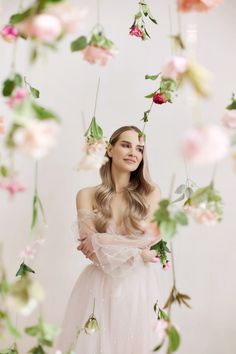 a woman in a white dress surrounded by flowers