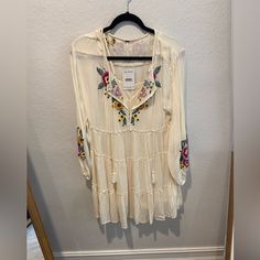 Beautiful White Free People Dress With Embroider Detail. Size Xs New With Tags Attached. Please Note Slight Damage To Interior Dress On The Fourth Picture. Beige Long Sleeve Boho Dress For Spring, Cream Long Sleeve Summer Dress, Casual Boho Dress With Floral Embroidery For Spring, Cream Long Sleeve Mini Dress For Beach, Flowy Mini Dress With Floral Embroidery For Beach, Flowy Floral Embroidered Mini Dress For Beach, Spring Beige Rayon Dress, White Long Sleeve Rayon Dress, Cream V-neck Boho Dress For Spring