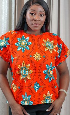 African Print Blouse With Elastic At The Sleeves. Beautiful Print Kitenge Shirts Women, Floral Print Crew Neck Blouse For Vacation, Vacation Blouse With Floral Print And Crew Neck, Vacation Crew Neck Blouse With Floral Print, Vacation Floral Print Crew Neck Blouse, Cotton Blouse With Vibrant Print And Short Sleeves, Orange Printed Short Sleeve Tops, Red Floral Print Crew Neck Blouse, Red Crew Neck Blouse With Floral Print