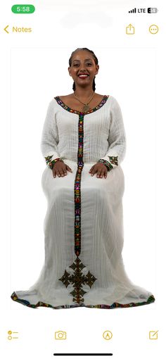 Simple Ethiopian dress with a beautiful trim and hand embroidery. This dress comes with full netela (two panel 2m scarf). Model is wearing a A/M but It can be custome made in any size. please send your measurements when you place your order and your phone number. phone numbers are required on the shipping form. Traditional Fitted Dress With Embroidered Border, Fitted Traditional Dress With Embroidered Border, Elegant Dresses With Embroidered Border For Traditional Ceremonies, Fitted Maxi Dress With Embroidered Border, Elegant Fitted Dress With Embroidered Border, Elegant Maxi Dress With Embroidered Border, Fitted Wedding Dress With Embroidered Border, Fitted Long Sleeve Dress With Embroidered Border, Traditional White Dress With Embroidered Sleeves