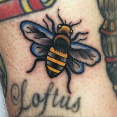 a tattoo with a bee on it