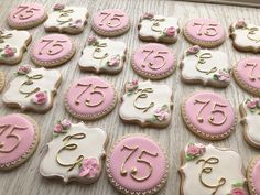 pink and white decorated cookies with gold numbers