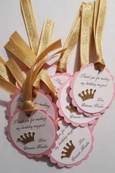 three tags with gold foil on them and some ribbons tied to the back of them