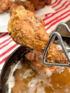 fried chicken being cooked in a frying pan