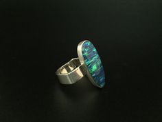 Hi everyone, just wanted to let you know we are open and shipping daily. One of a kind opal and sterling silver ring in unique band design. This fire opal has been cultured in Japan over a three year period and contains the same chemical composition as natural opal. As with the rest of this line of jewelry the quality and workmanship is unrivaled. This line has sold in my San Francisco store for more than twice the etsy price we are offering. Modern Sterling Silver Opal Ring, Modern Sterling Silver Oval Opal Ring, Modern Oval Opal Ring, Oval Opal Ring Stamped 925, Fire Opal Earrings, Blue Fire Opal, Unique Bands, Larimar Pendant, Fire Opal Ring