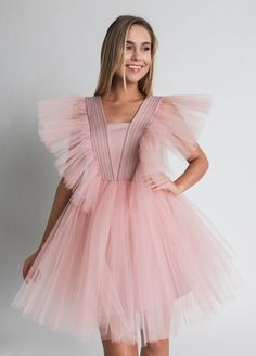 Tulle Dress for Women with Tutu Skirt and Tulle Filling on Shoulders. Perfect choice as a Bridesmaid Dress or in White as Wedding Dress. This Unique dress really puts on a show with tulle filling silhouette. Short Tulle Dress is enough to put anyone in the mood for partying. A.P.Line is more than just a custom-made clothing brand; we are the style experts, the design gurus and the professional seamstresses readily at your service. Express your individuality with a bit of modern luxury that has b Princess Style Tulle Dress For Prom Season, Fitted Princess Style Tutu Dress For Evening, Princess Style Fitted Evening Tutu Dress, Princess Style Fitted Tutu Evening Dress, Princess Style Fitted Tutu Dress For Evening, Sleeveless Tulle Princess Dress For Bridesmaids, Pink Sleeveless Tulle Bridesmaid Dress, Tulle Fairy Dress For Wedding, Princess Style Ruffled Tutu Dress For Prom