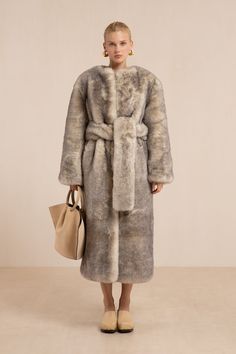 A sumptuous long sleeve faux fur coat with adjustable waist tie. — Faux fur — Collarless — Long sleeve — Waist tie White Blanket Coat, Belted Long Sleeve Fur Coat For Fall, Luxury Belted Fur Coat For Fall, Fall Faux Fur Belted Outerwear, Winter Faux Fur Belted Outerwear, Chic Belted Faux Fur Outerwear, Belted Faux Fur Coat For Winter, Winter Belted Faux Fur Coat, Chic Long Sleeve Belted Fur Coat