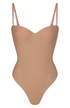 Find SKIMS Body Molded Underwire Bodysuit on Editorialist. This sleek, contouring bodysuit supports your curves while smoothing and cinching in your core. The lightly lined, molded cups with underwire enhance your bust and the removable straps let you wear the shapewear your way. Back hook-and-eye closure Molded underwire cups Removable, adjustable straps Thong back Snap cotton-lined gusset 61% polyamide, 39% elastane Hand wash, line dry Imported Body Molding, Shapewear, Cocoa, Onyx, Adjustable Straps, Hand Wash, Sleek, Gift Ideas, How To Wear