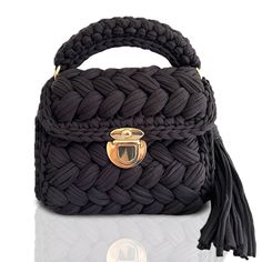 a black handbag with a gold buckle on it