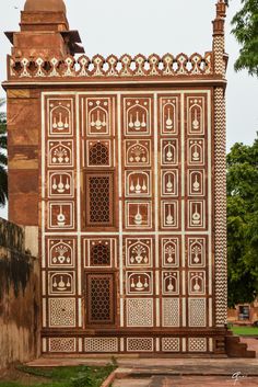 an intricately designed gate in the middle of a park