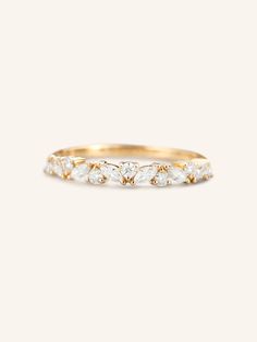 a gold and white diamond ring with five diamonds on the side, set in 18k yellow gold