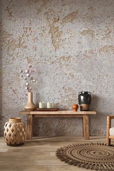 a room with a table, chair and vases on the floor next to it