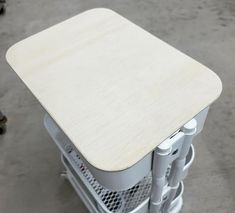 a white table sitting on top of a metal rack