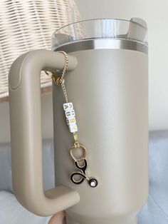 This cute custom stethoscope tumbler cup charm is sure to add a flair to your Tumbler as an accessory. Colors may appear slightly different in person versus on the computer screen and our photos all show natural lighting.  This would make a great accessory to your water bottle tumbler, tumbler cup accessory, 40 oz tumbler cup charm, water bottle handle charm, simple modern water bottle accessory, water bottle charm, water bottle headed handle charm, cup charm, cup bling, gift for nurse, nurse week gifts, nurse appreciation, medical student gift, nurse graduation gift, and more. **Item does not come with cup. This is for the charm only** Nurse stethoscope charm in gold chain option Gold chain will have a matching gold charm (refer to photo) 🎀CARE INSTRUCTIONS 100% Handmade, please handle w Nurse Gift Diy, Stanley Cup Accessories Diy, Stanley Cup Christmas Gift Ideas, Stanley Cup Charms, Stanley Cup Gift Ideas, Stanley Cup Accessories, Nurse Week Gifts, Stanley Accessories