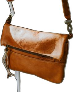 Brown Flap Saddle Bag With Adjustable Strap, Brown Leather Flap Bag, Brown Saddle Bag With Leather Lining And Flap, Brown Leather Saddle Bag With Flap And Leather Lining, Brown Flap Bag With Adjustable Strap, Brown Soft Leather Flap Bag For Travel, Dark Tan Leather Crossbody Shoulder Bag, Cognac Crossbody Flap Bag With Adjustable Strap, Brown Leather Crossbody Saddle Bag