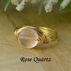 "Coin Shaped Peach Moonstone Gemstone and Sterling Silver, Yellow or Rose Gold Filled Wire Wrapped Ring; Custom Made to Size MATERIALS: ❀ This coin shaped peach moonstone gemstone bead wire wrapped ring is handmade with an approximately 8mm stone bead and your choice of wire for the band. ❀ The wire ring band choices are Sterling Silver Filled wire, Argentium Sterling Silver wire (tarnish resistant sterling silver wire), Yellow Gold Filled wire, or Rose/Pink Gold Filled wire. ❀ This listing is f Rose Quartz Crystal Ring In Rose Gold, Wire Wrapped Rose Gold Rings, Round Rose Quartz Birthstone Jewelry, Wire Wrapped Crystal Ring For Anniversary, Wire Wrapped Rose Quartz Round Jewelry, Azurite Ring, Amazonite Ring, Green Amazonite, Bead Wire