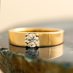 a diamond ring sitting on top of a rock