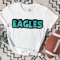 This custom personalized tshirt is the perfect spirit wear for teams, sports fans, cheer squads, and dance teams, making it an ideal kids gift or personalized gift for any game day outfit. Show your school spirit, team spirit, or create a motivational tee with a custom nickname, inside joke, or personalized message. This unisex shirt is great for sports apparel and cheer apparel, allowing you to design a unique team shirt or sports fan tee. DESIGN YOUR OWN CUSTOM TSHIRT * Personalize with any na Cheerleading T-shirt With Glitter Print Crew Neck, Team Spirit T-shirt With Glitter Print For Cheerleading, Game Day Glitter Print Crew Neck T-shirt, Team Spirit Crew Neck T-shirt With Glitter Print, Team Spirit Glitter Print Crew Neck T-shirt, Casual Game Day T-shirt With Glitter Print, Crew Neck T-shirt With Glitter Print For Team Spirit, Casual T-shirt With Glitter Print For Game Day, Sporty Crew Neck T-shirt With Glitter Print