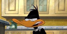 an animated duck wearing a top hat in a kitchen with cupboards and counter tops