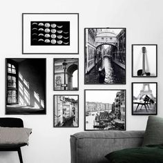 black and white photographs hang on the wall above a gray couch in a living room