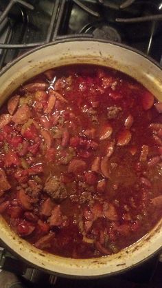 a large pot filled with lots of food on top of a burner oven stove